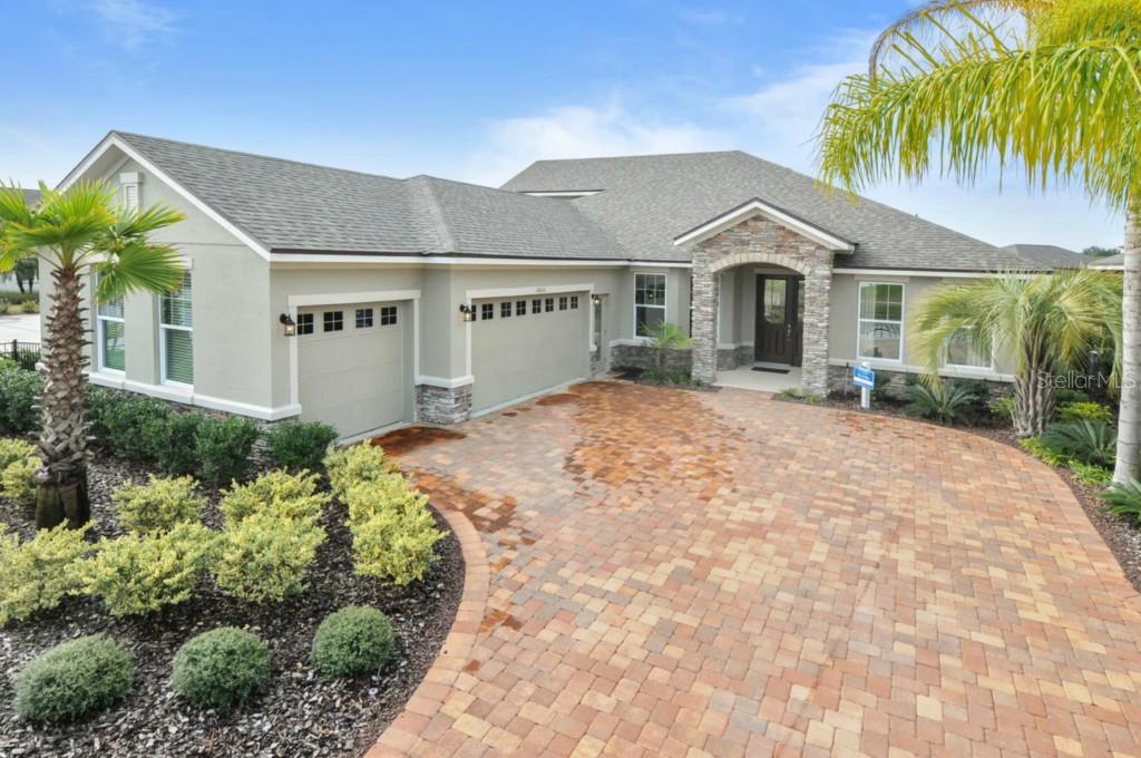 2860 North Point Boulevard Kissimmee, FL 34744 - Photo 1 of 1 a front view of a house with a yard and garage