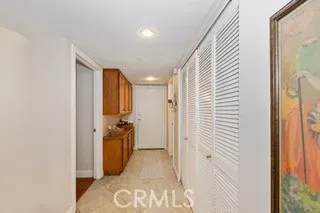 a view of a hallway with closet and a bathroom