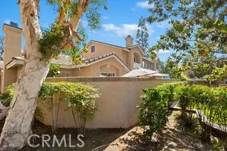 a view of a tree front of the house