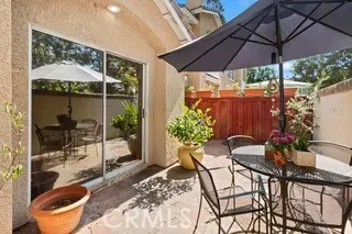 a patio with a patio table and chairs