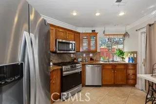 a kitchen with stainless steel appliances granite countertop a stove a sink and a refrigerator