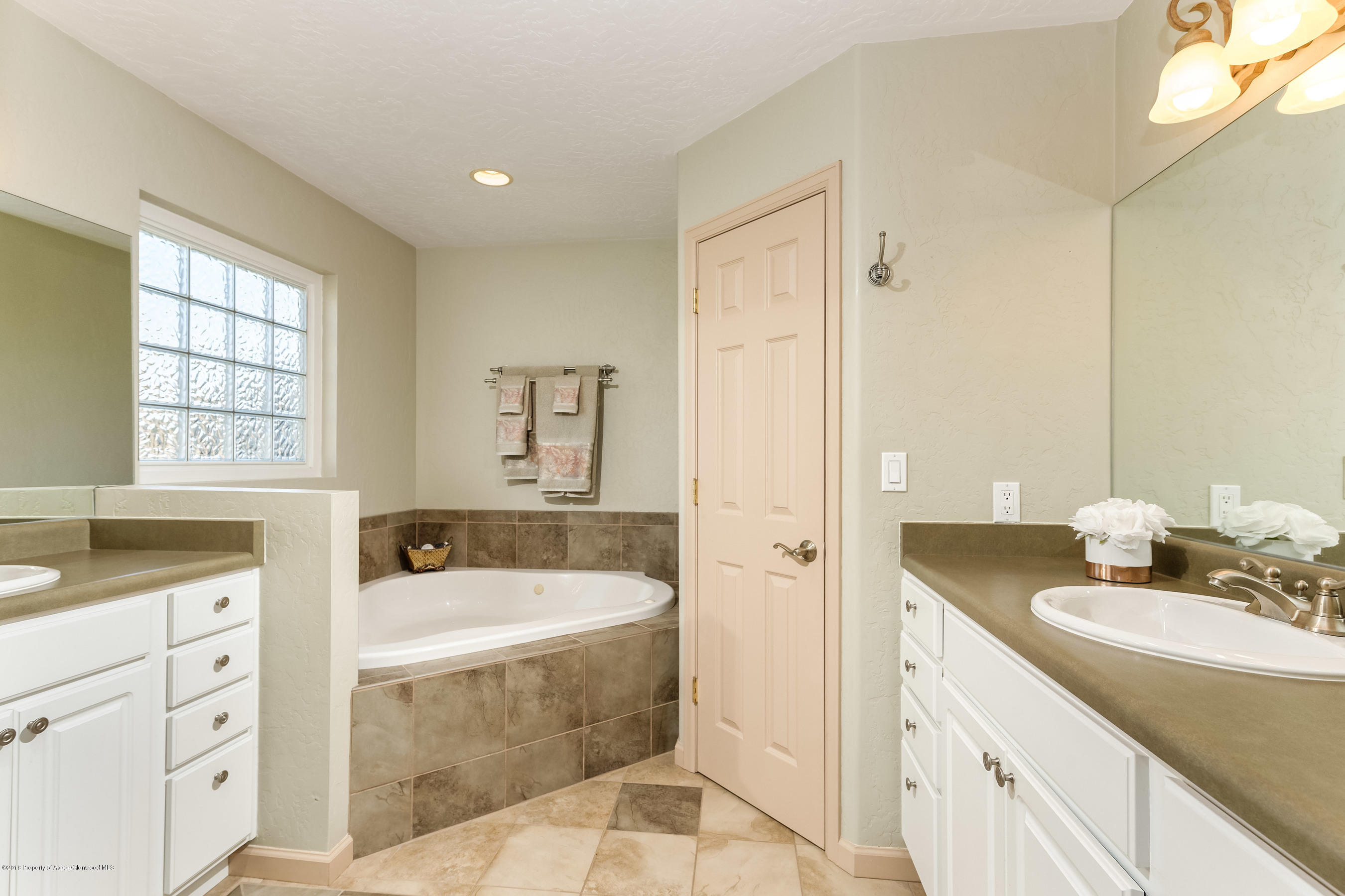 1359 County Road 294 Rifle, CO 81650 - Photo 16 of 31 a spacious bathroom with a tub sink and mirror