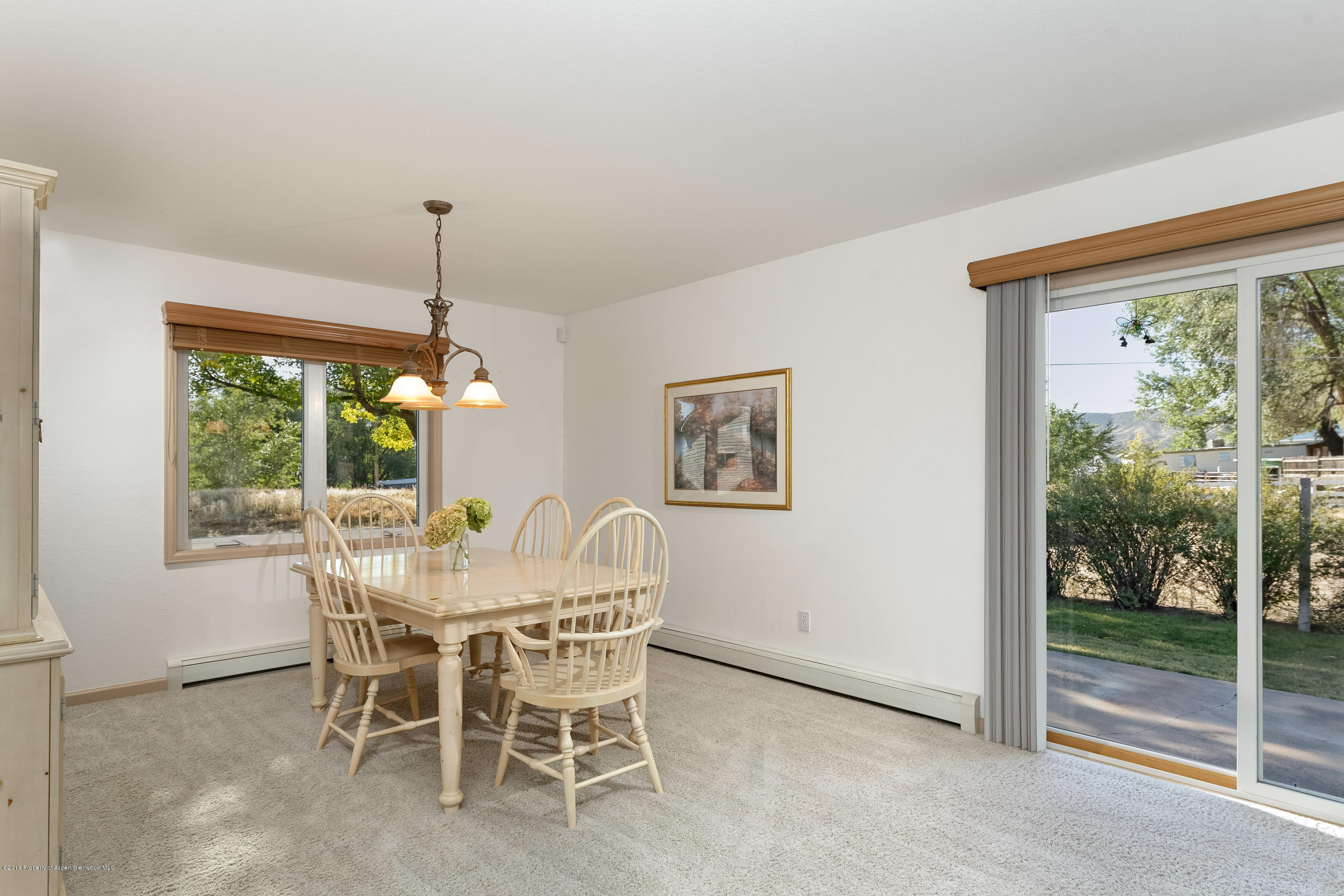 1359 County Road 294 Rifle, CO 81650 - Photo 9 of 31 a view of a dining room with furniture large windows and wooden floor