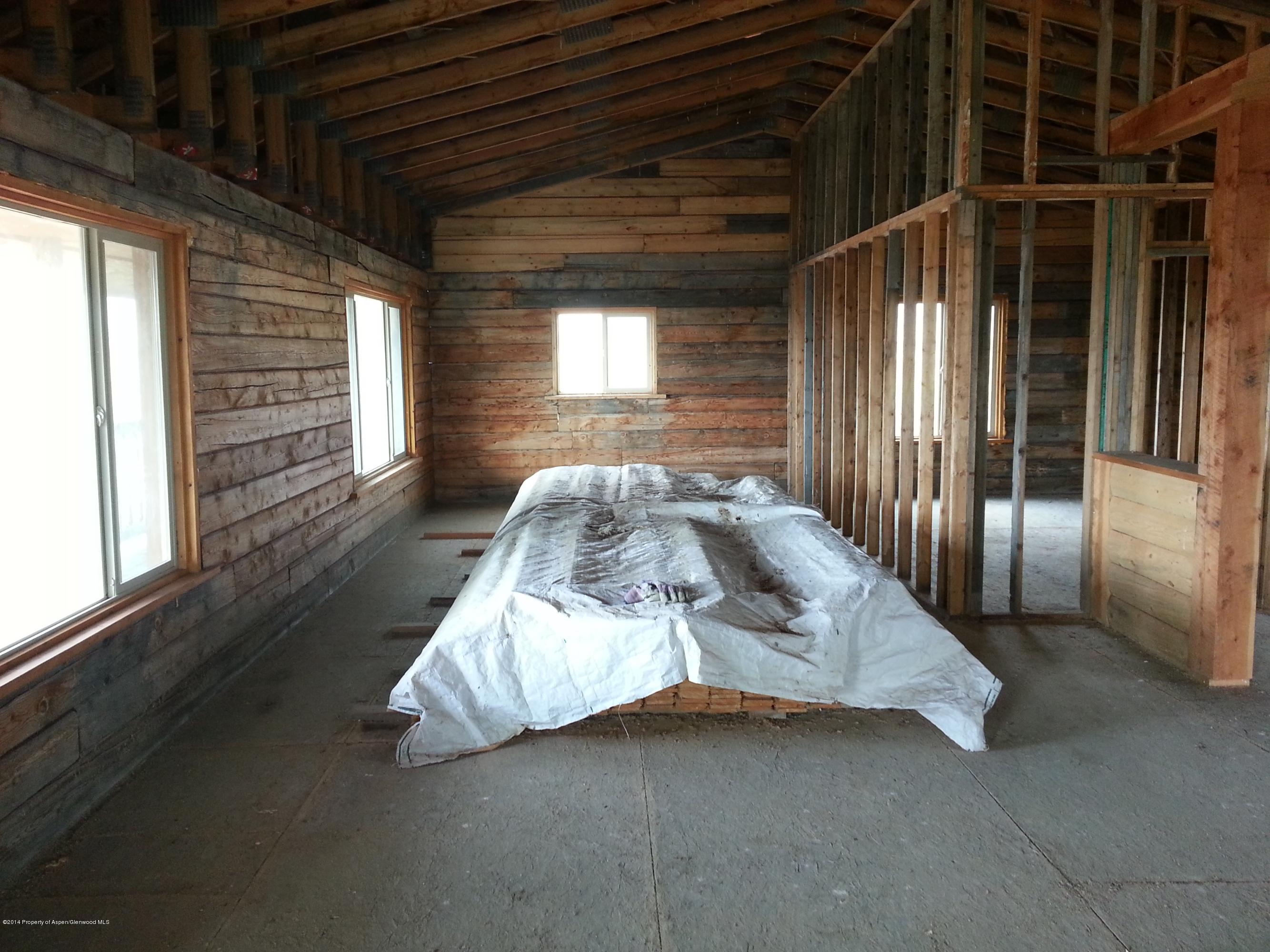 2519 County Road 210 Rifle, CO 81650 - Photo 8 of 16 a bed sitting in a room next to a window