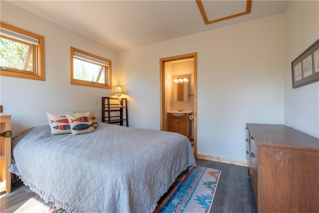 96 L Road Silverthorne, CO 80498 - Photo 25 of 35 a bedroom with a bed and a lamp on the dresser