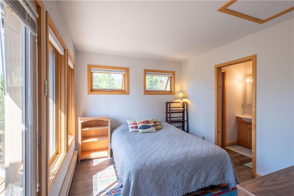 96 L Road Silverthorne, CO 80498 - Photo 27 of 35 a bedroom with a bed and wooden floor