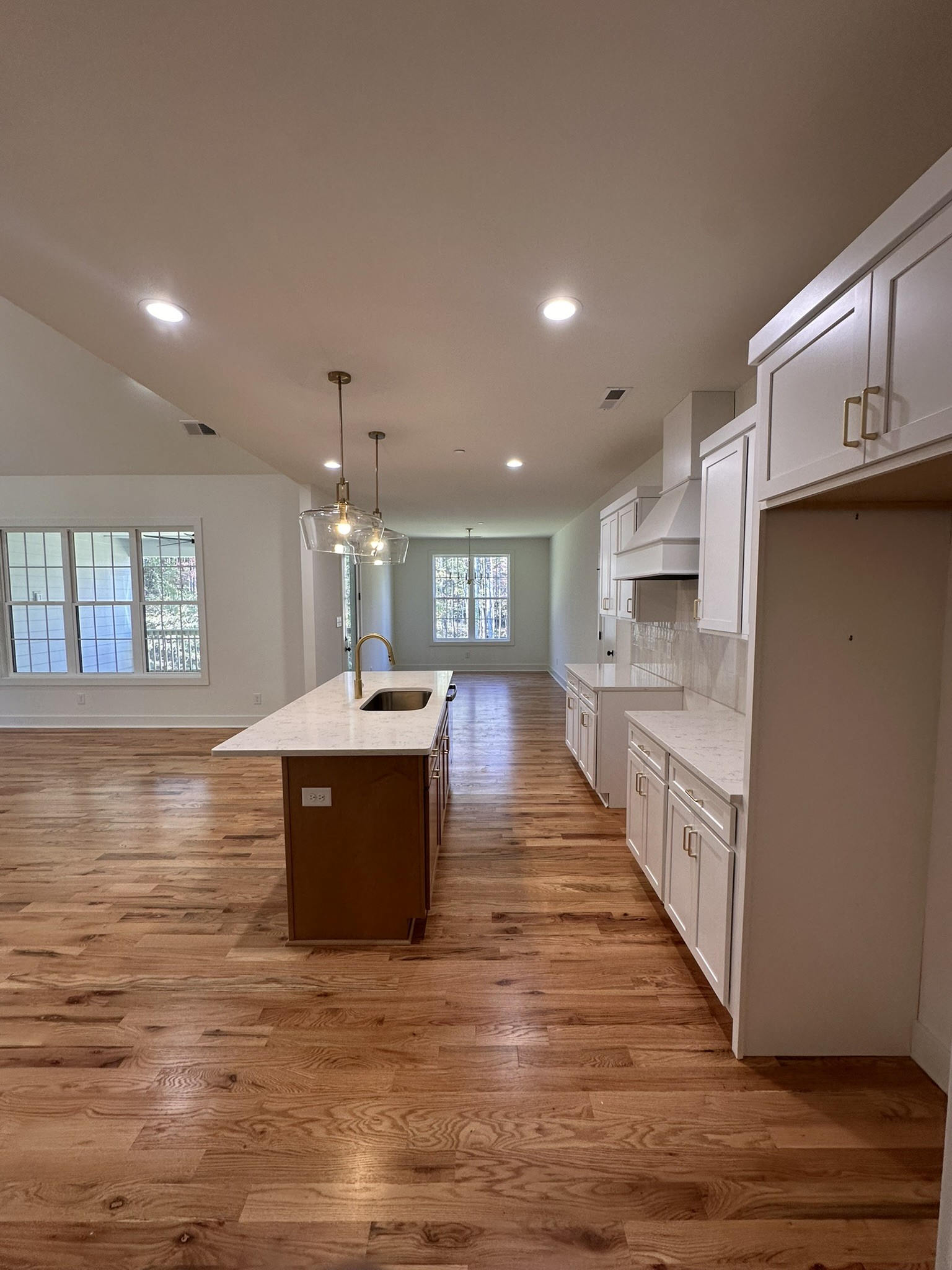 1324 Rooster Rdg Road Joelton, TN 37080 - Photo 3 of 15 a large white kitchen with kitchen island a sink wooden floor and a view of living room