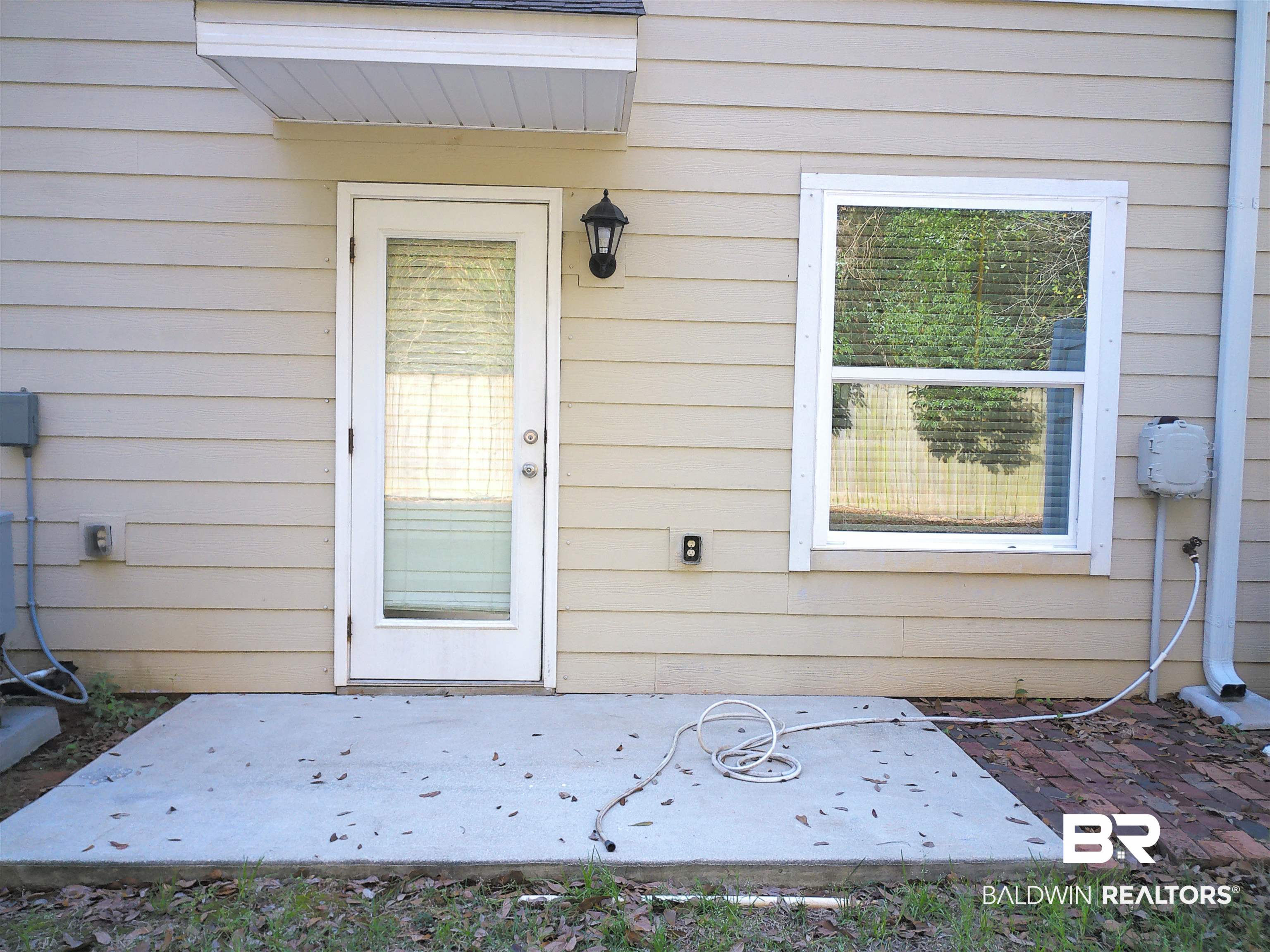 25806 Pollard Road, Unit 23 Daphne, AL 36526 - Photo 13 of 16 Entrance to property with a patio area