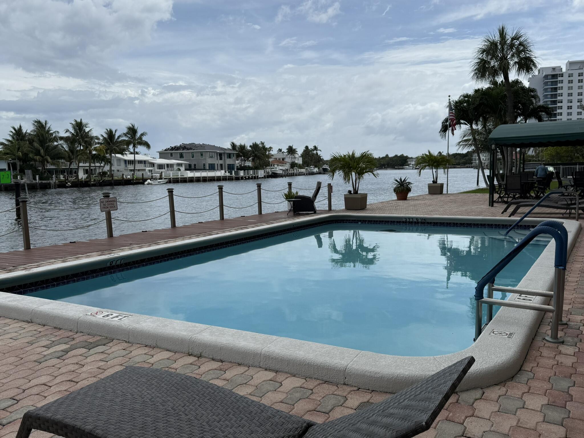 2611 North Riverside Drive, Unit 703 Pompano Beach, FL 33062 - Photo 73 of 81 a view of a swimming pool with a lounge chair