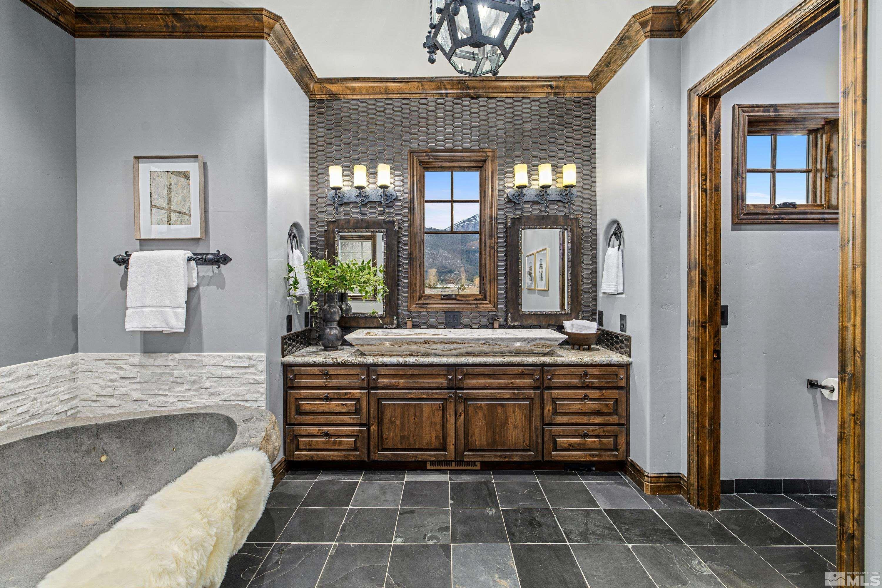 18250 Lake Vista Road Washoe Valley, NV 89704 - Photo 17 of 40 a spacious bathroom with a granite countertop double vanity and a mirror