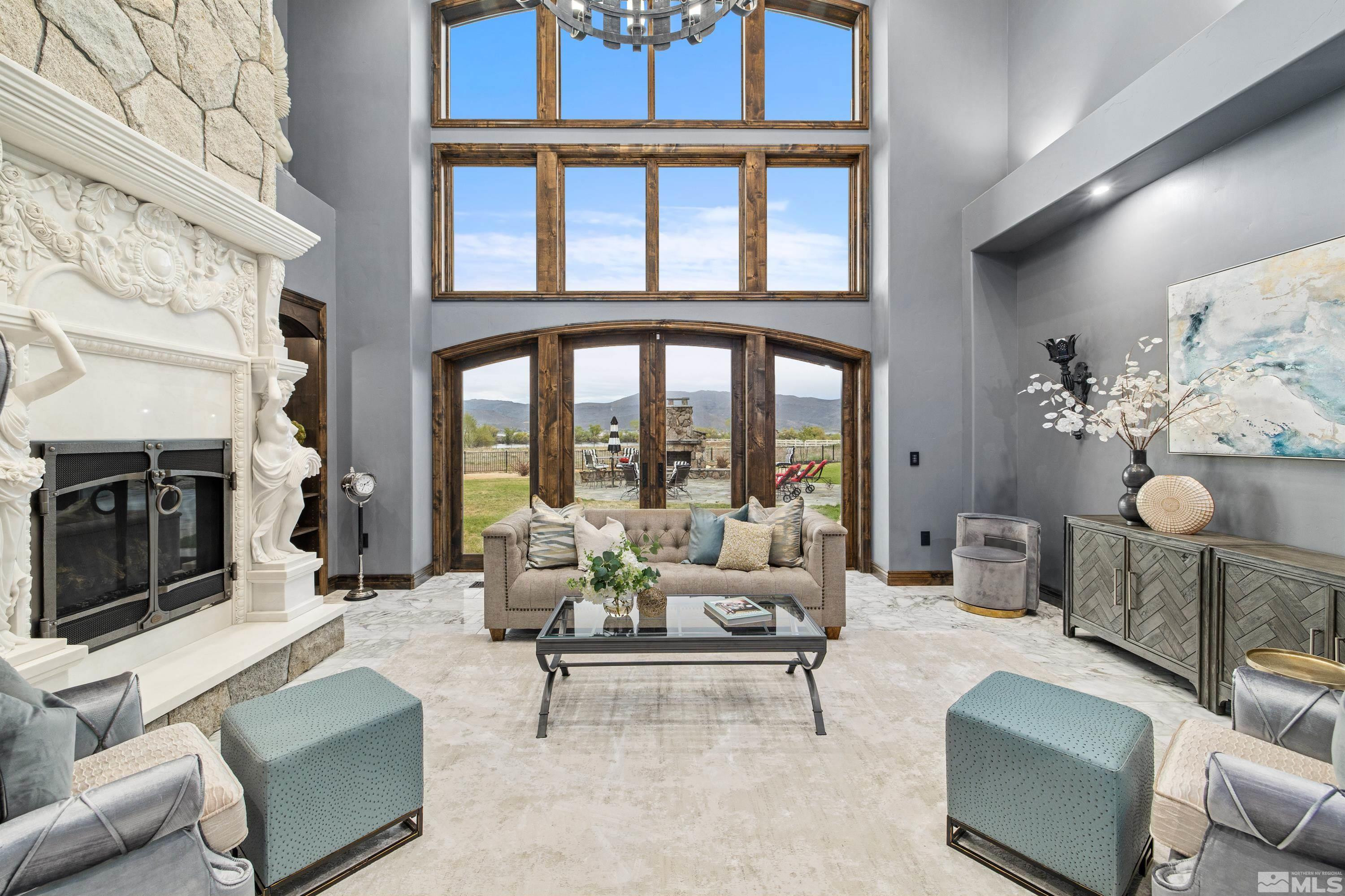 18250 Lake Vista Road Washoe Valley, NV 89704 - Photo 4 of 40 a living room with furniture a fireplace and a floor to ceiling window