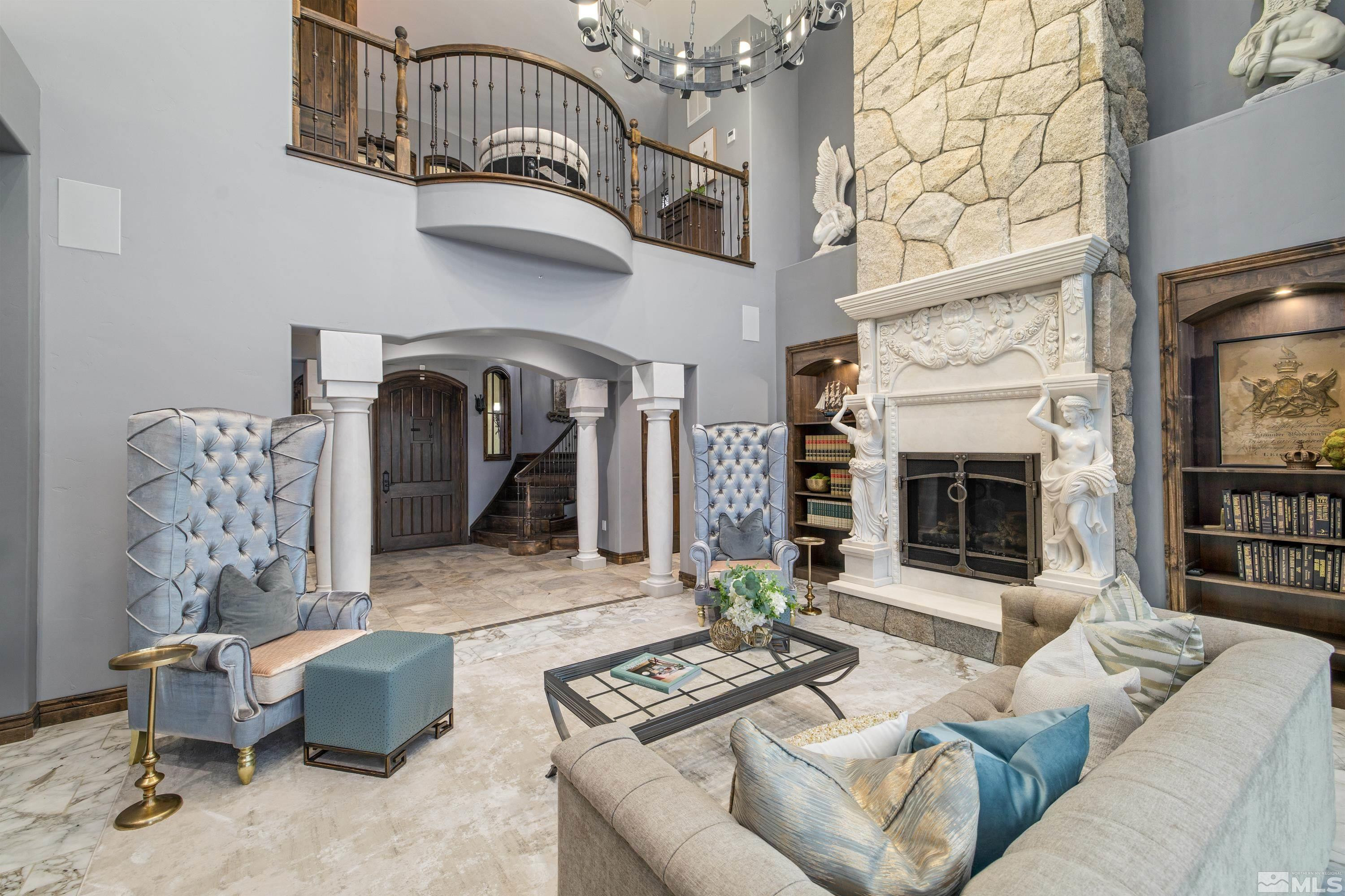 18250 Lake Vista Road Washoe Valley, NV 89704 - Photo 5 of 40 a living room with furniture a fireplace and a chandelier