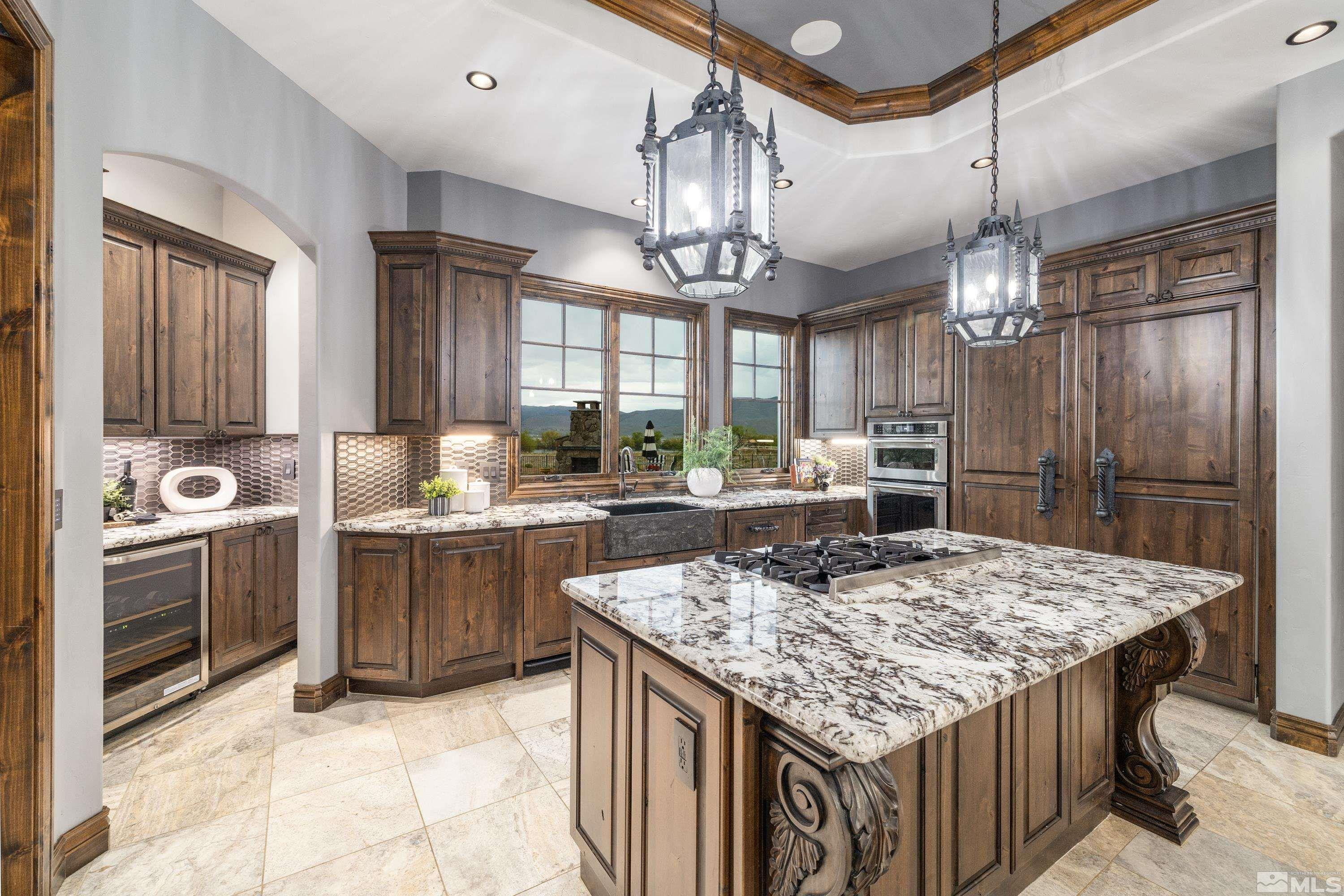 18250 Lake Vista Road Washoe Valley, NV 89704 - Photo 8 of 40 a kitchen with kitchen island granite countertop a sink stove and refrigerator