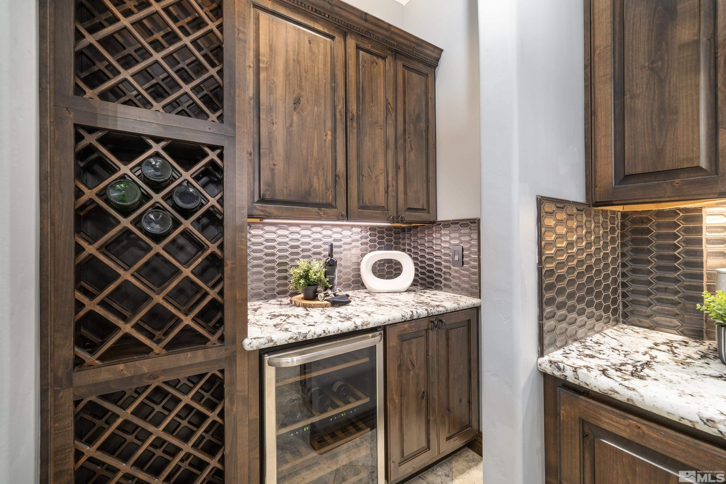 18250 Lake Vista Road Washoe Valley, NV 89704 - Photo 9 of 40 a kitchen with granite countertop wooden cabinets and a stove top oven