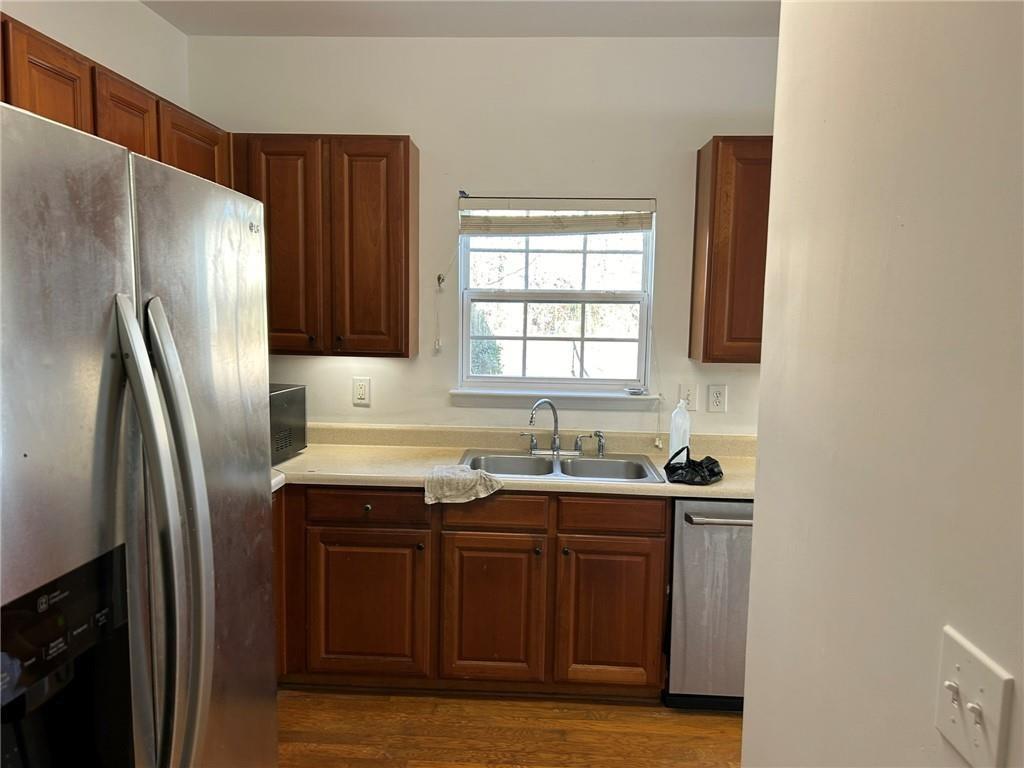 2099 Meadow Peak Road Duluth, GA 30097 - Photo 11 of 13 a kitchen with stainless steel appliances granite countertop a sink a refrigerator and a stove
