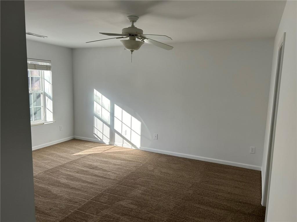 2099 Meadow Peak Road Duluth, GA 30097 - Photo 3 of 13 an empty room with windows and fan