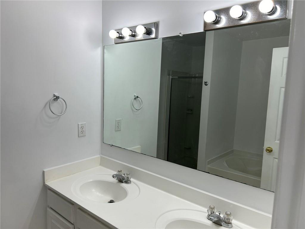 2099 Meadow Peak Road Duluth, GA 30097 - Photo 4 of 13 a bathroom with a sink and a mirror