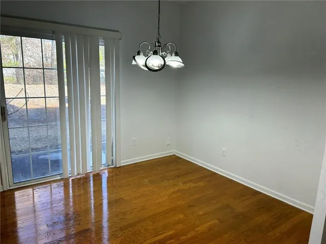 a view of an empty room with a chandelier