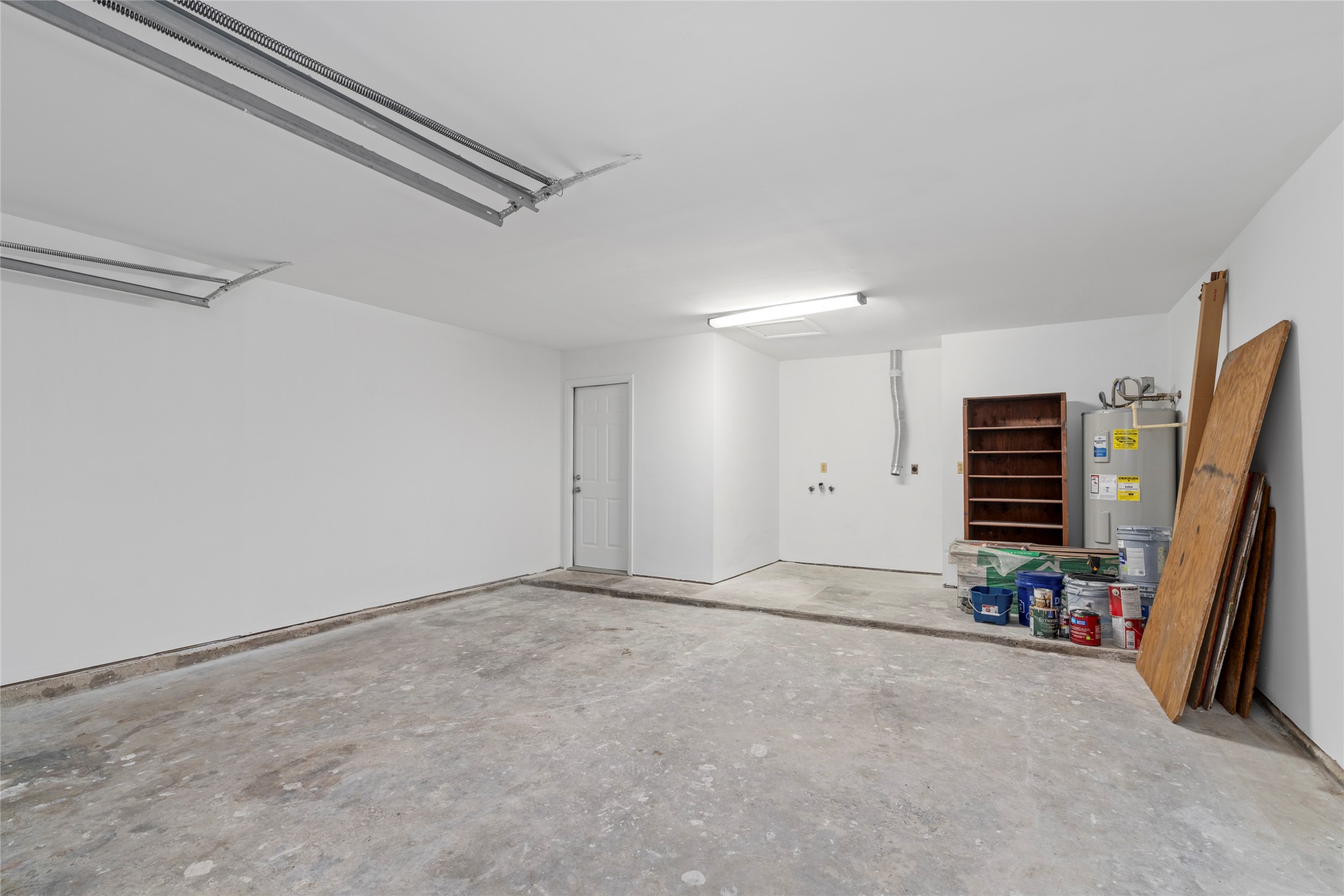 4715 Roserock Lane Spring, TX 77388 - Photo 14 of 17 Clean two-car garage center! Offers ample parking space, utility hookups, and extra storage shelves.