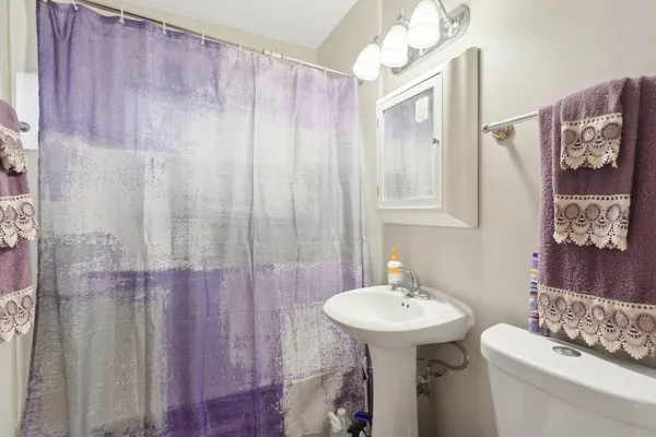 a bathroom with a sink a mirror and a toilet