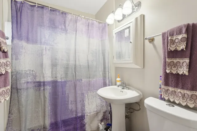 a bathroom with a sink a mirror and a toilet