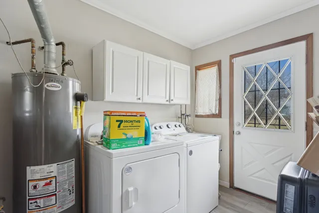 a utility room with cabinets washer and dryer