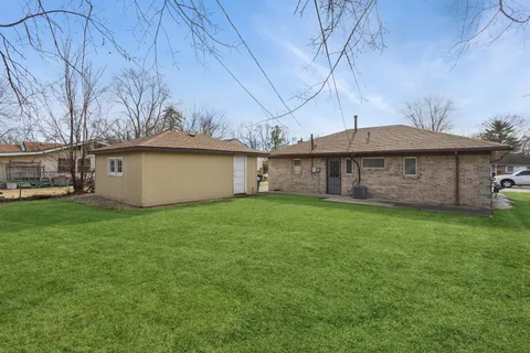 a view of a house with a backyard