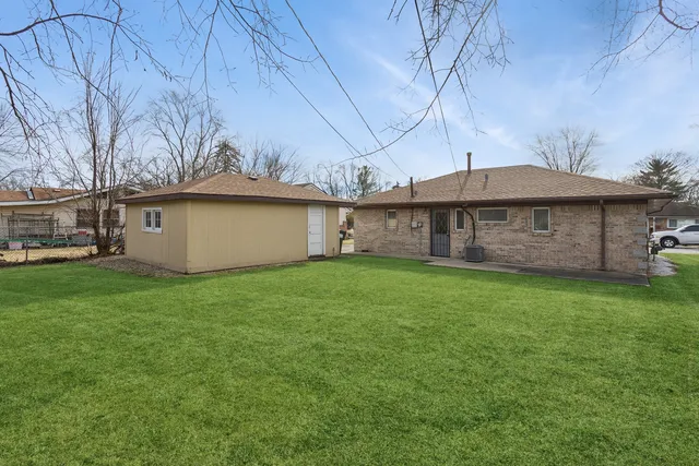 a view of a house with a backyard