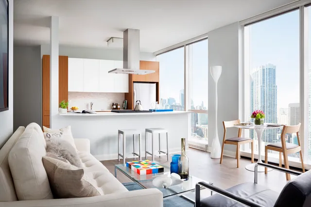 a living room with furniture and floor to ceiling windows