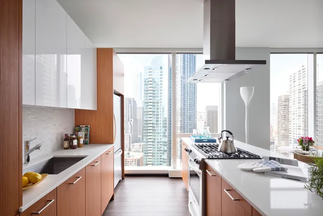 a kitchen with a sink stove and cabinets