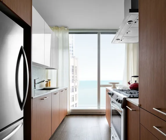a kitchen with stainless steel appliances a sink stove and a refrigerator
