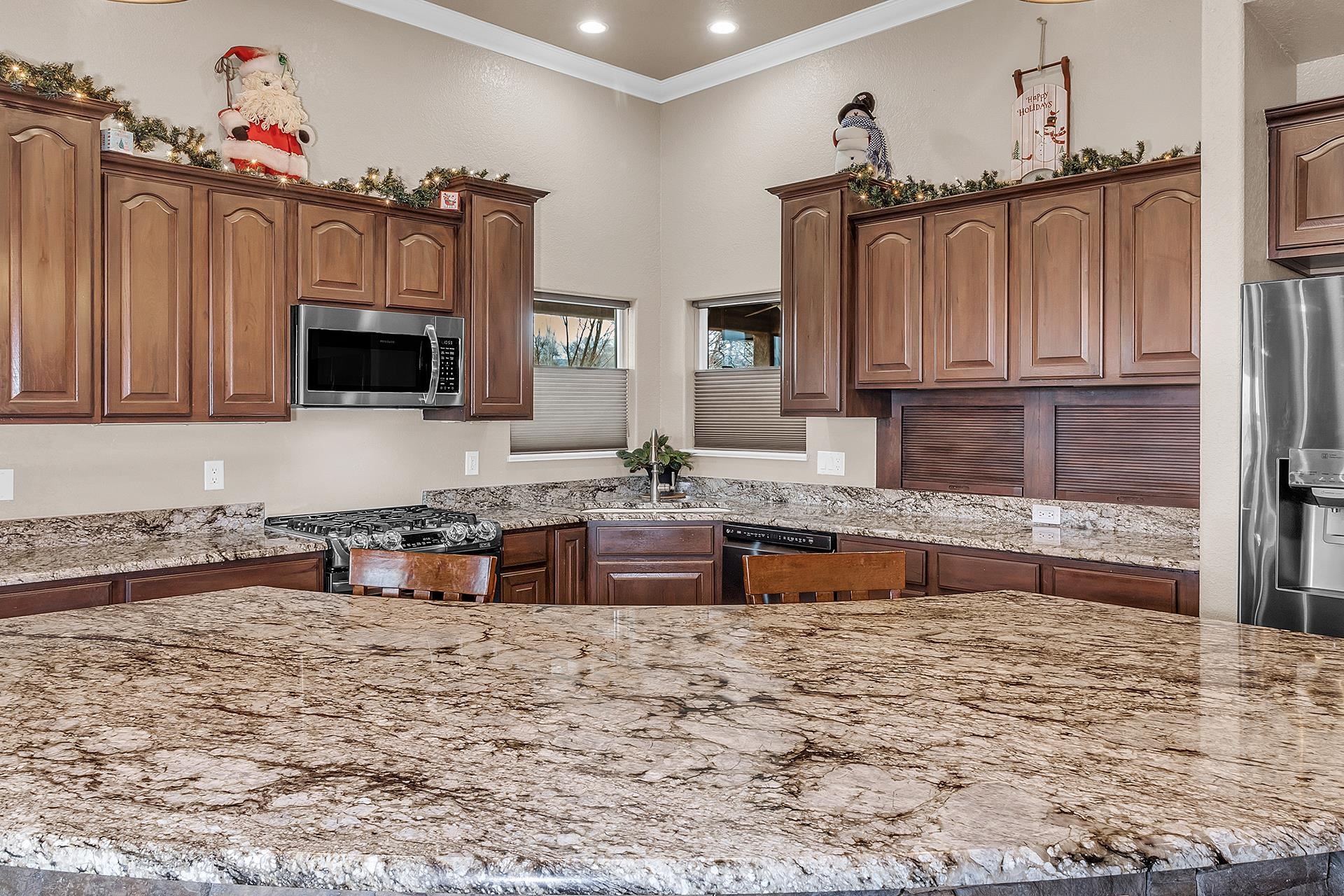 894 25 Road Grand Junction, CO 81505 - Photo 11 of 42 a kitchen with granite countertop a sink a stove top oven a granite counter tops and a white cabinets