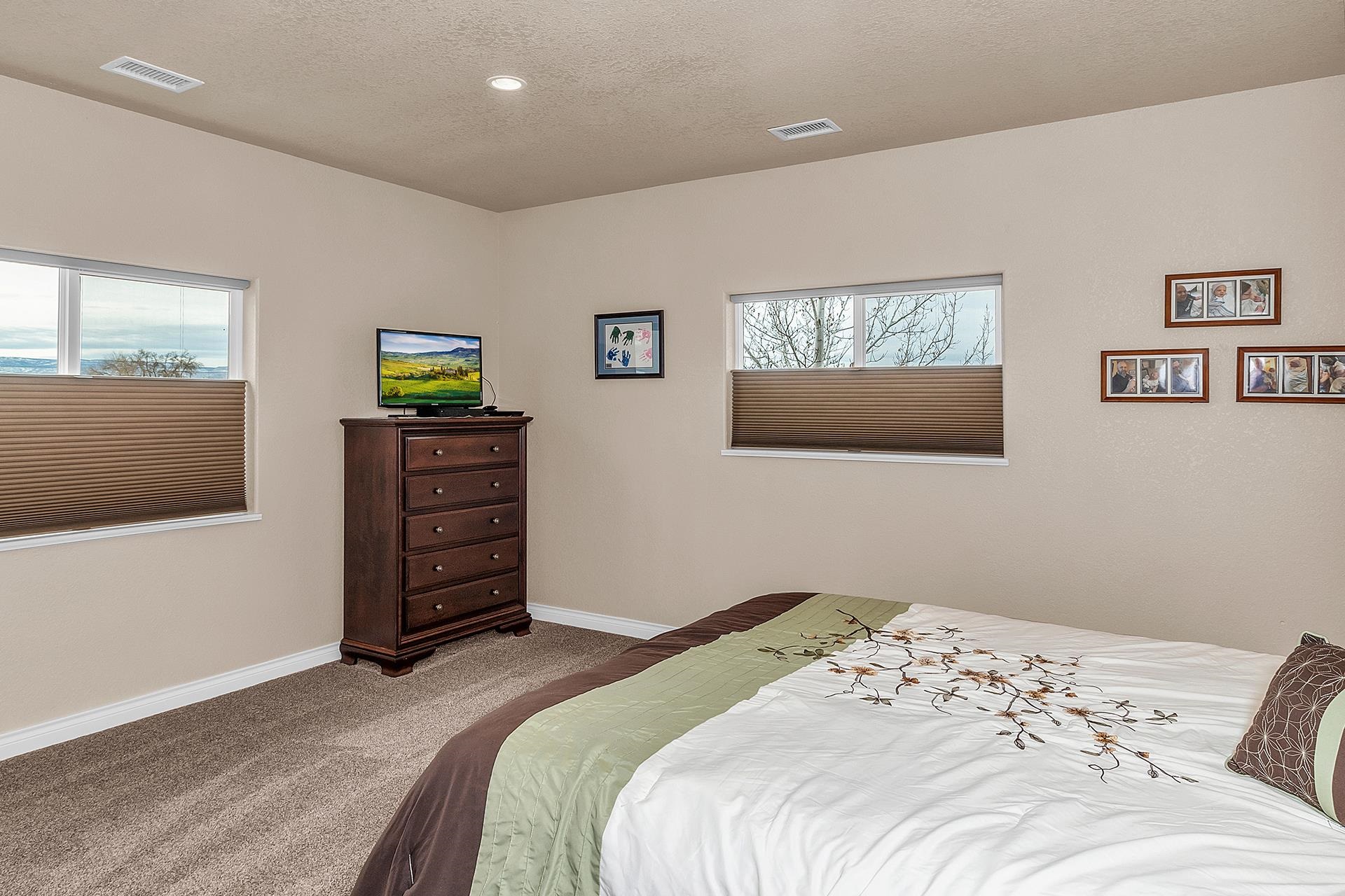 894 25 Road Grand Junction, CO 81505 - Photo 15 of 42 a bedroom with a bed and a flat screen tv
