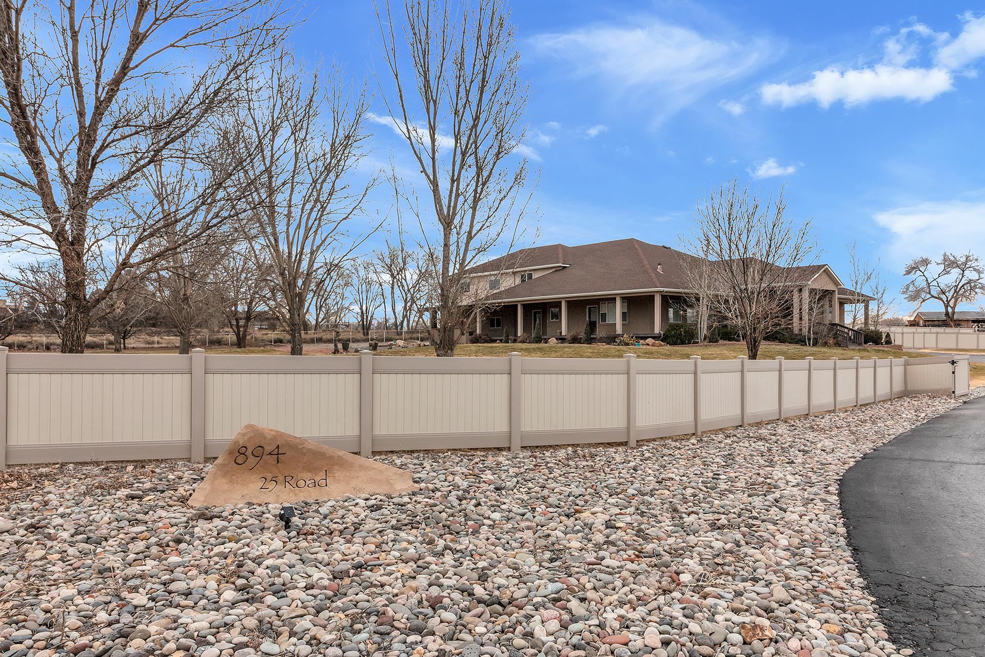 894 25 Road Grand Junction, CO 81505 - Photo 5 of 42 a front view of a house with a yard