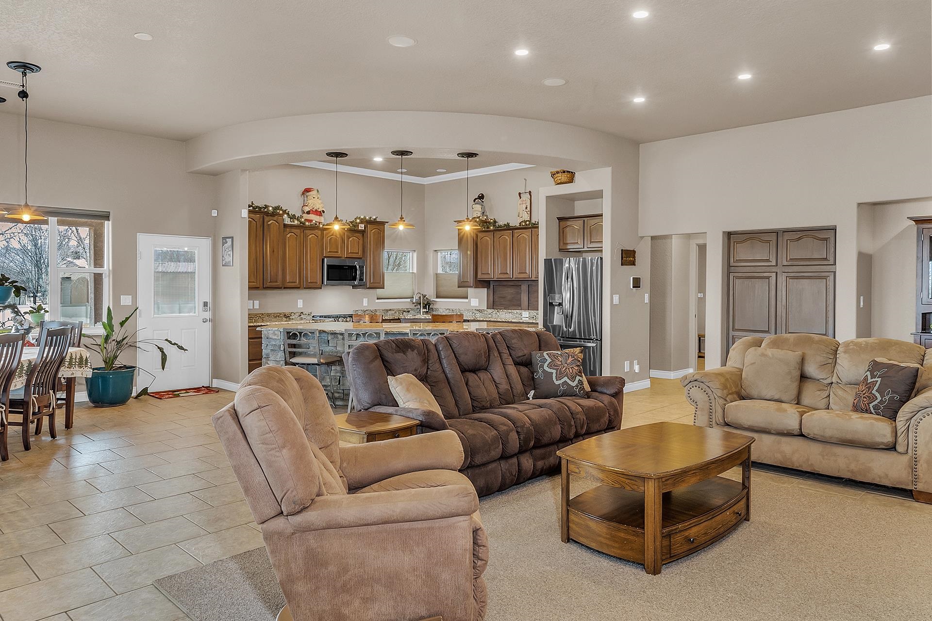 894 25 Road Grand Junction, CO 81505 - Photo 8 of 42 a living room with furniture kitchen view and a chandelier