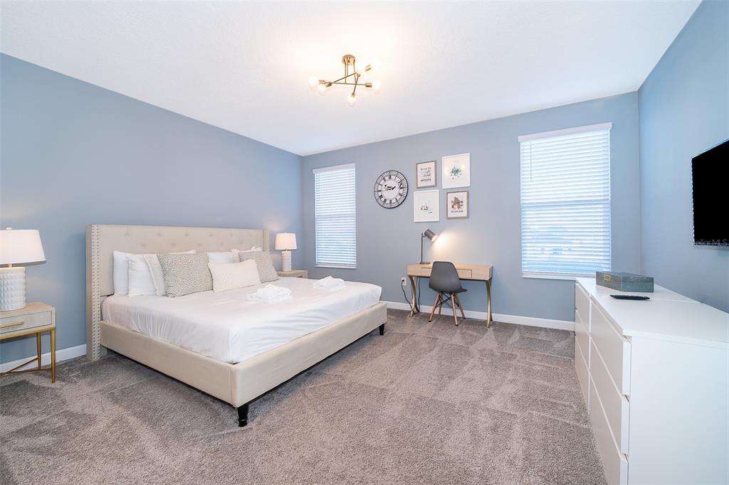 830 Sticks Street Davenport, FL 33896 - Photo 5 of 37 a bedroom with a bed and a flat screen tv