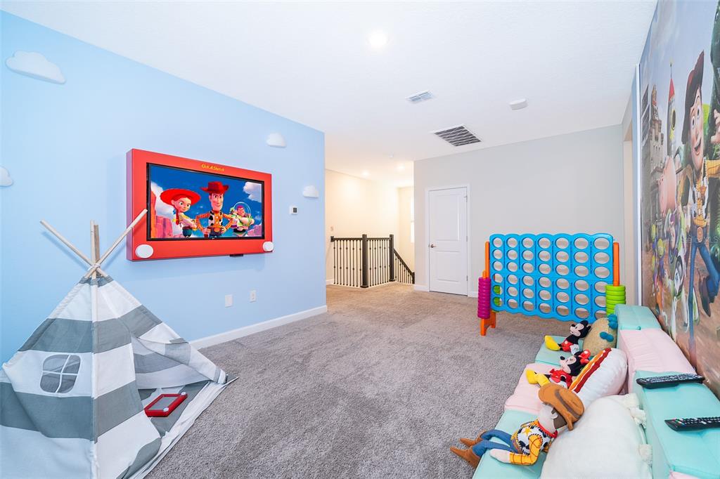 830 Sticks Street Davenport, FL 33896 - Photo 9 of 37 a bedroom with a bed and a couch