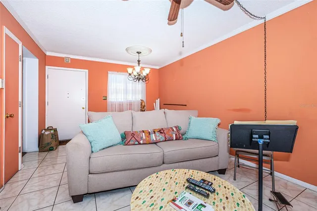 a living room with furniture and a chandelier