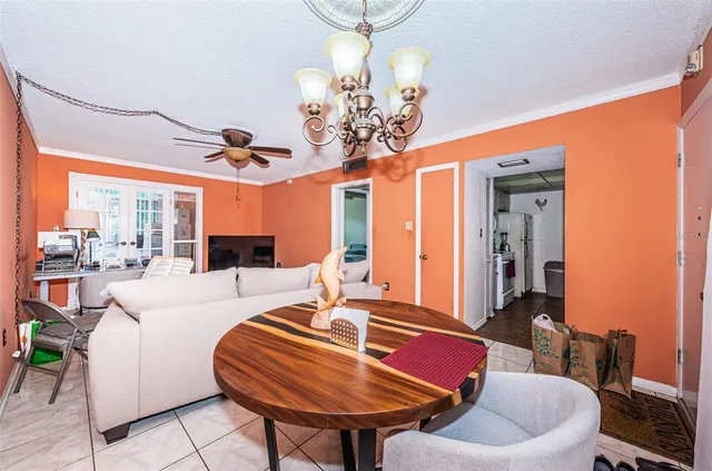 a living room with furniture a table and a chandelier