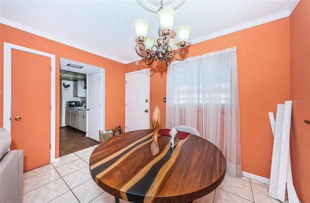 a room with wooden floor table and chairs