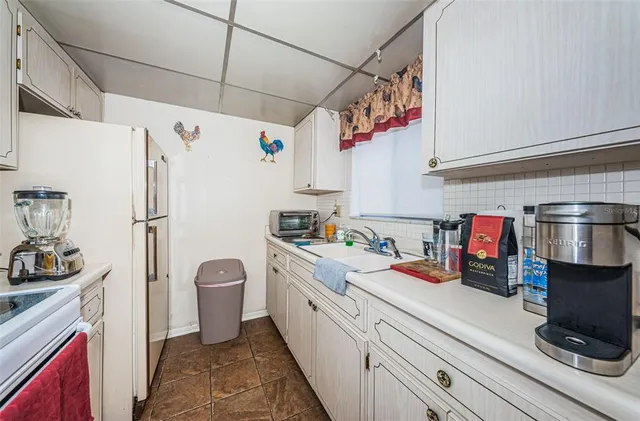 a kitchen with stainless steel appliances a sink and refrigerator