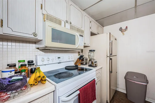 a kitchen with a stove and a refrigerator