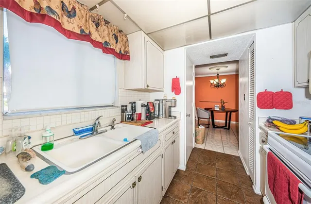 a kitchen with a sink appliances and cabinets