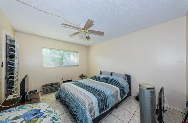 a bedroom with bed and a window