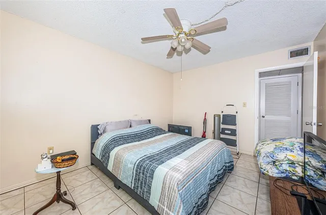 a bedroom with double bed and a chandelier