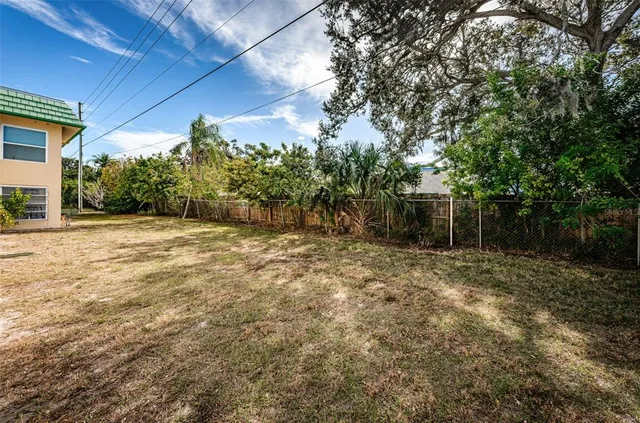 a view of a backyard with large trees