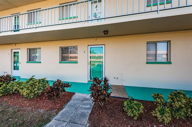 a flower garden in front of a house