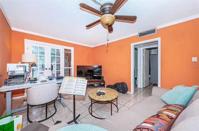 a living room with furniture a flat screen tv and a window