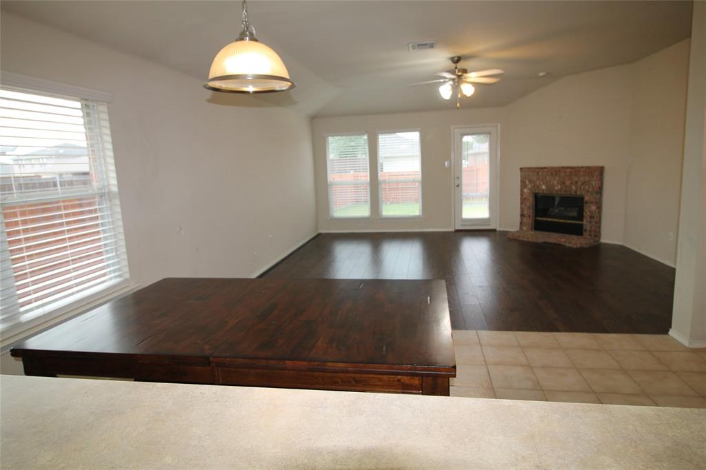 4188 Cherry Ridge Drive Frisco, TX 75033 - Photo 13 of 25 a living room with a fireplace furniture and a chandelier