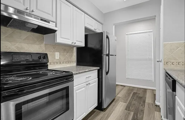 a kitchen with a stove and a microwave